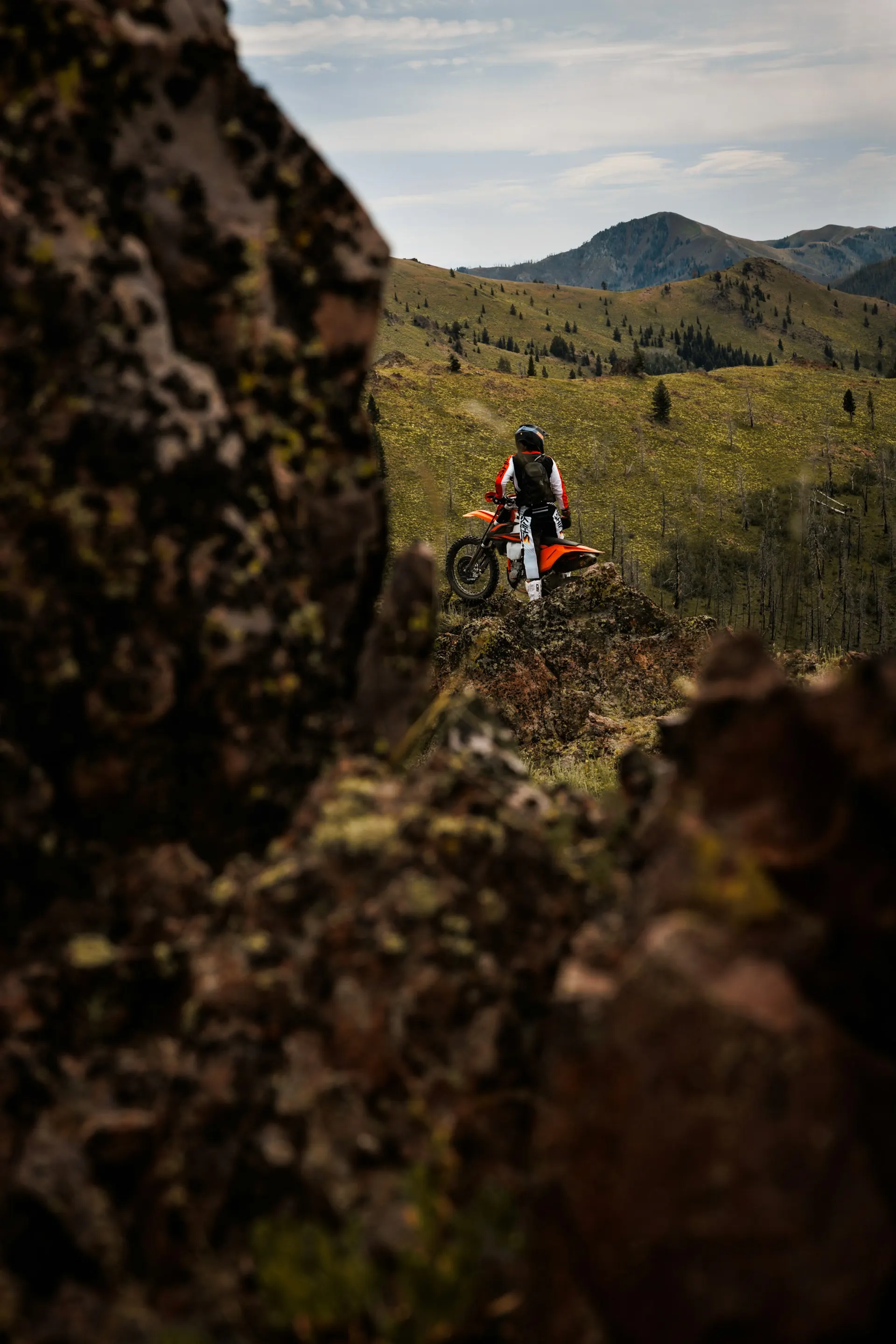 Dirt bike rider on a high-country ridge